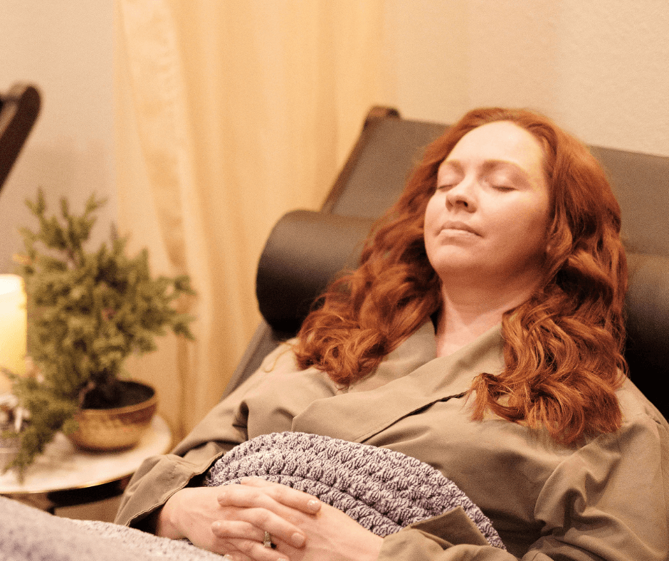 woman relaxing in robe in chair in salt lounge